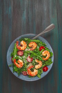 Shrimp salad with arugula and cherry tomatoes, with parmesan cheese, healthy food