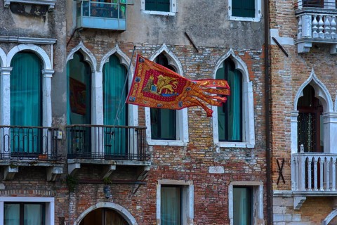 Waving flag of the Republic of Venice on a palace, Venice, Veneto, Italy