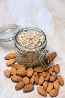 Almonds and ground almonds in glass, Prunus amygdalus