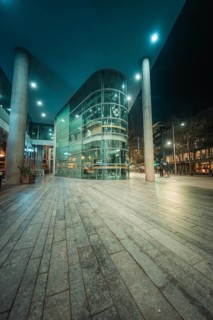 Architecturally modern building at night with bright lights and urban environment, New Year's Eve