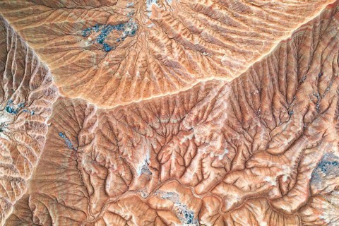 A stunning aerial view of a desert landscape showcasing intricate erosion patterns The natural
