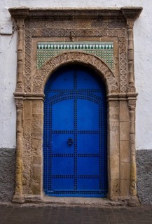 A blue door with ornate arch and decorative mosaic patterns in antique style, Essaouira, Morocco