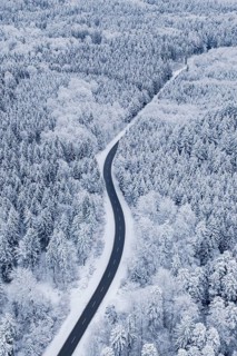 Winding road through snowy forest, aerial view, Gechingen, Calw district, Germany