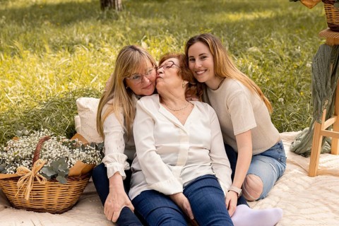 A heartwarming scene of a grandmother, mother, and daughter sharing a moment of love and connection