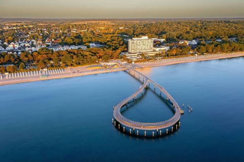Aerial view over Maritim Seebrücke / maritime pier over the Baltic Sea at seaside resort