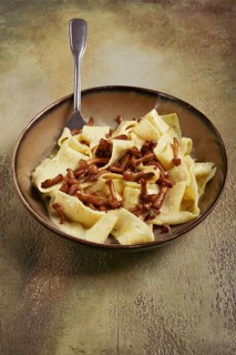 Pasta papardelle, in creamy garlic sauce, with mushrooms, traditional Italian cuisine, pasta