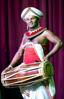 Sri Lankan musician with a traditional drum, Young Men's Buddhist Association, Kandy, Central