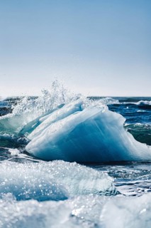 Sparkling ice formations glisten under the sun at Diamond Beach, Iceland, creating a stunning