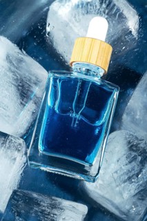 Top view of a face care serum or oil for men showcased in a clear dropper bottle, emphasizing its