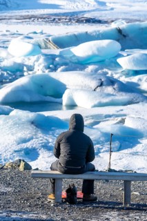 A photographer photographing the floating icebergs in the Jokulsarlon glacier lagoon in Iceland.