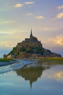 Picturesque view of Mont Saint-Michel on an island with medieval architecture at dusk, summer, Le