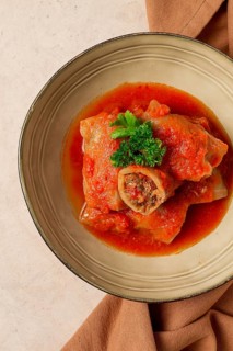 Stuffed cabbage rolls, with minced meat, in tomato sauce, on a beige background, food and drink,