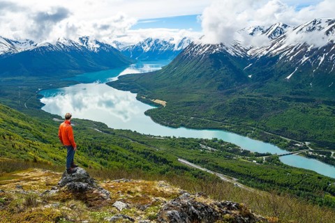 Climber enjoying the view, Slaughter Ridge Trail, view of snowy mountains and turquoise blue Kenai