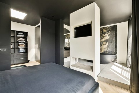 A sleek, modern bedroom featuring a neutral color palette, minimalist furniture, and innovative