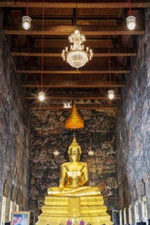Golden Buddha statue, Phra Buddha Trilokachet, surrounded by exquisite murals, interior view of the