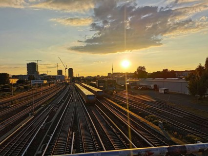 Sunset over train tracks in an urban landscape with warm evening mood, Berlin