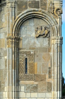 Ornamented window and relief sculpture of a bird of prey on the east façade of the cross-domed