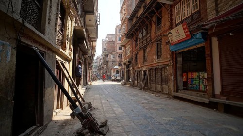 Narrow, quiet alley in Kathmandu with traditional architecture and sunlight, houses are secured and
