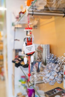 Traditional Black Forest jumping jack as a shop window decoration alongside other souvenirs, Calw