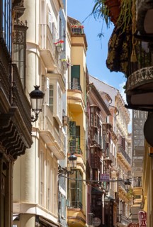 Narrow alley in the historic centre of Malaga with historic buildings and balconies, Malaga, Spain