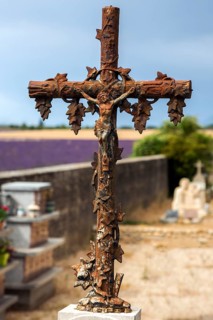 Cross with Jesus on a grave, cemetery in Puimoisson, Provence, region Provence-Alpes-Côte d'Azur,