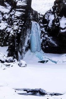 Frozen waterfall, Folaldafoss, snowy rock face, Sudausturland, Iceland