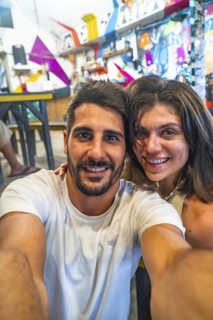 Tourists taking a selfie in a restaurant in siargao island, philippines, enjoying their holidays