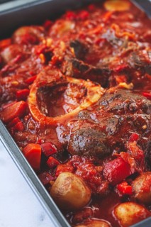 Ossobuco stew with vegetables, knuckle on the bone with new potatoes, in tomato sauce, homemade,