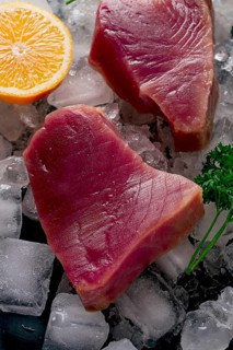 Fresh, raw steak, tuna fish, on ice, top view, close-up