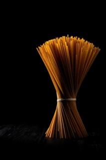 Low key photo of whole wheat semolina pasta rich in fiber. Organic linguine