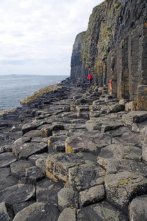 Rugged coastline with basalt columns and rocky surface by the sea, Staffa, Hebrides, Scotland,
