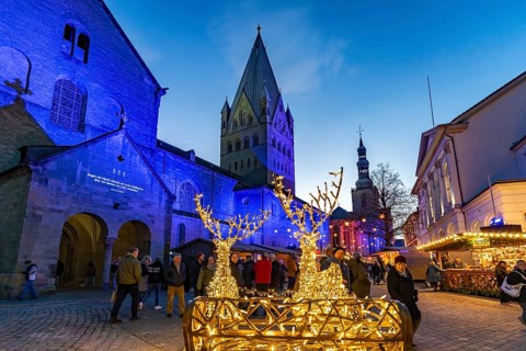 LED reindeer with sleigh at the Christmas market and St. Patrokli Cathedral in Soest at dusk, North