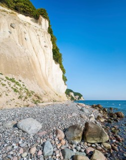 The chalk cliffs on the Baltic Sea, erratic blocks and flint pebbles on the shore, Jasmund National