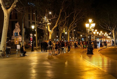 Night shot of catering and tourists on the Ramblas in Barcelona, Spain