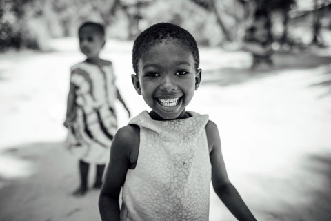 MICHAMVI KAE, ZANZIBAR - OCTOBER 17, 2025: A joyful young girl with a radiant smile looks directly