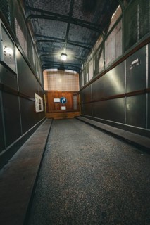 Industrial metal lift with illuminated interior, old Elbe tunnel, Hamburg, Germany