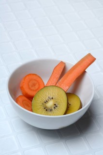 Sliced carrot and kiwi slices in peel, kiwi fruit and carrot