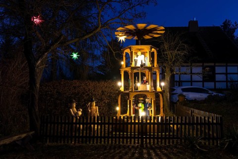 Christmas pyramid with wooden figures in the village of Unkersdorf in the evening, Dresden, Saxony,