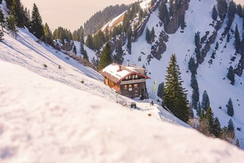 Holzberghütte is quietly situated on a snowy mountainside in the Alps, Hochgrat Mountains, Allgäu