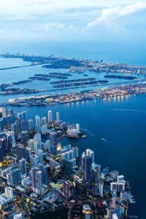 Aerial view of Miami skyline with skyscrapers Downtown Brickell and Miami Beach at night in Miami,