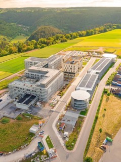 Modern buildings with solar panels in a rural setting, photographed from the air, construction of