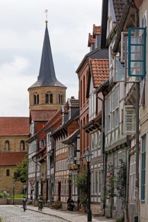 Facades of half-timbered houses in Brühlstrasse with the steeple of the Basilica of St. Godehard,