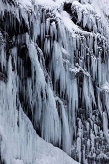 Icicles on the rock face at Skogafoss waterfall, Sudurland, Iceland