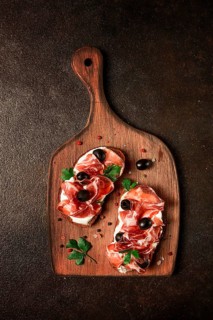 Sandwich with cream cheese, prosciutto with olives, breakfast