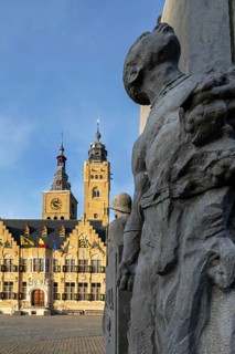 Detail of statue Jacques de Dixmude showing African slave on Market square with town hall and belfy