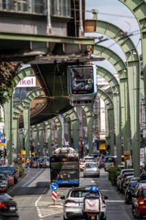 Train of the Wuppertal suspension railway runs along Kaiserstraße in the Wuppertal-Vohwinkel