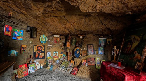 Religious icons and altar table in a cave, spiritual atmosphere, chapel, Agios Nikolaos, rock