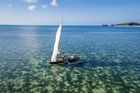 MICHAMVI KAE, ZANZIBAR - OCTOBER 14, 2025: High angle view of people sailing a traditional