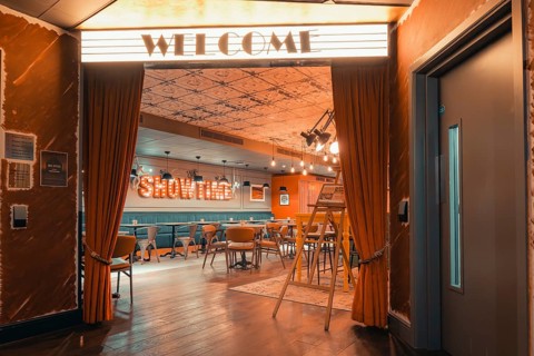 Inviting retro-style entrance hall with cinema lighting and warm ambiance, Ibis Styles Hotel,