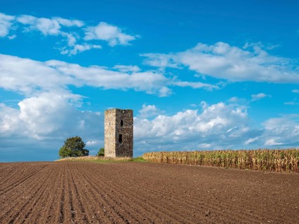 The Blue Tower in a ploughed field in autumn, medieval watchtower in the Magdeburger Börde, blue